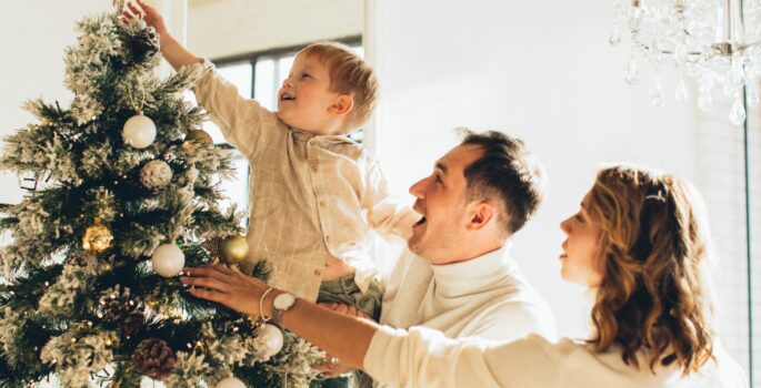 Image of family decorating their Christmas Tree