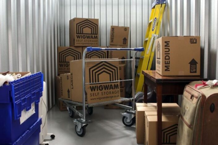 Organised Wigwam Self Storage unit with labelled boxes, furniture and tools, showing effective self storage tips for packing and space use.