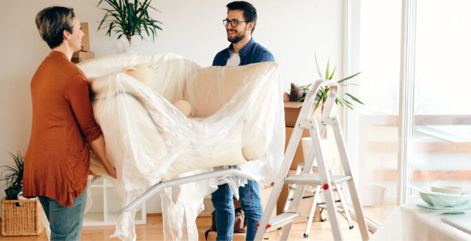 couple carrying furniture